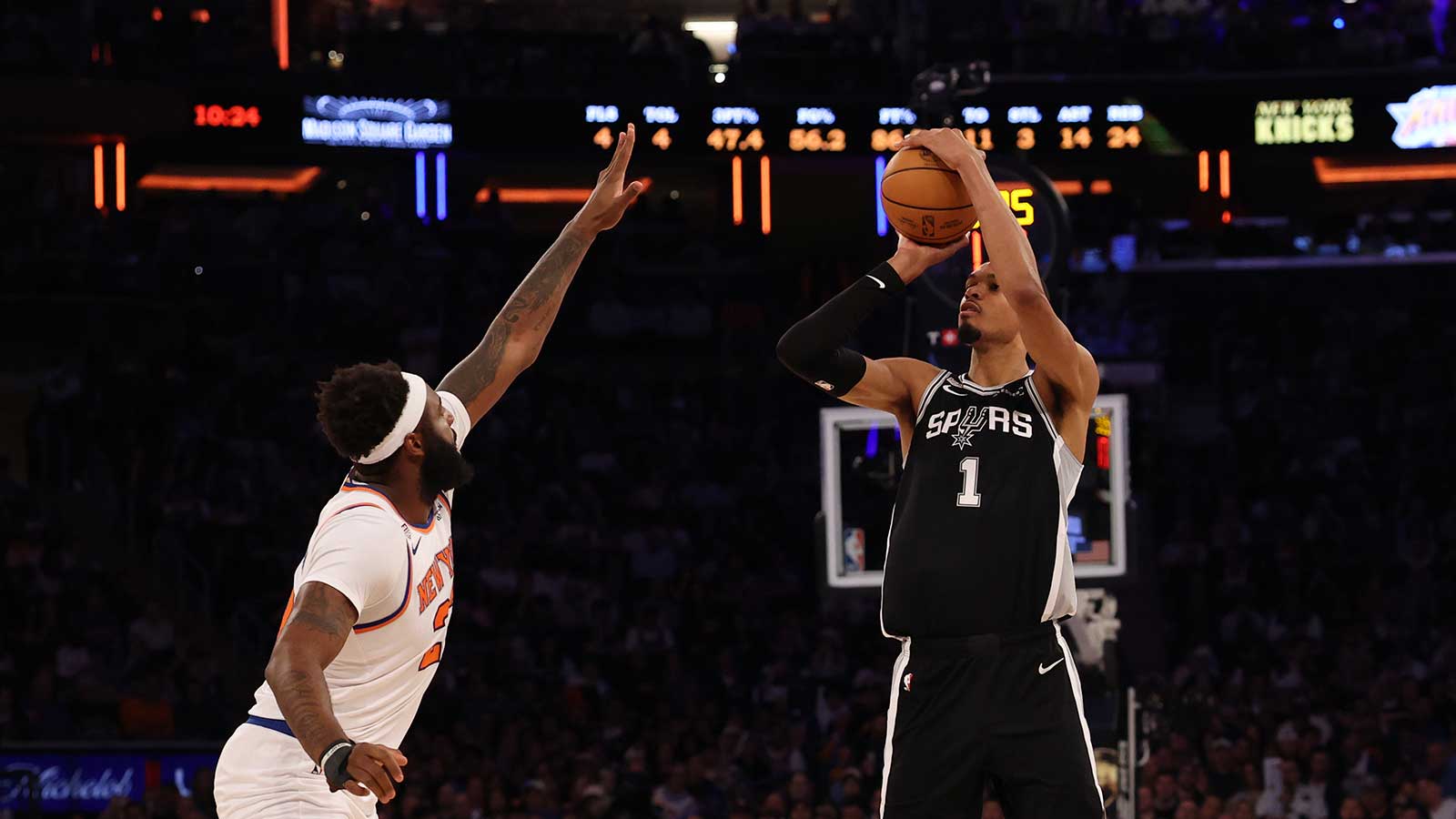 San Antonio Spurs forward Victor Wembanyama (1) shoots the ball as New York Knicks center Mitchell Robinson (23) defends during game three of the 2026 NBA Finals at Madison Square Garden. 
