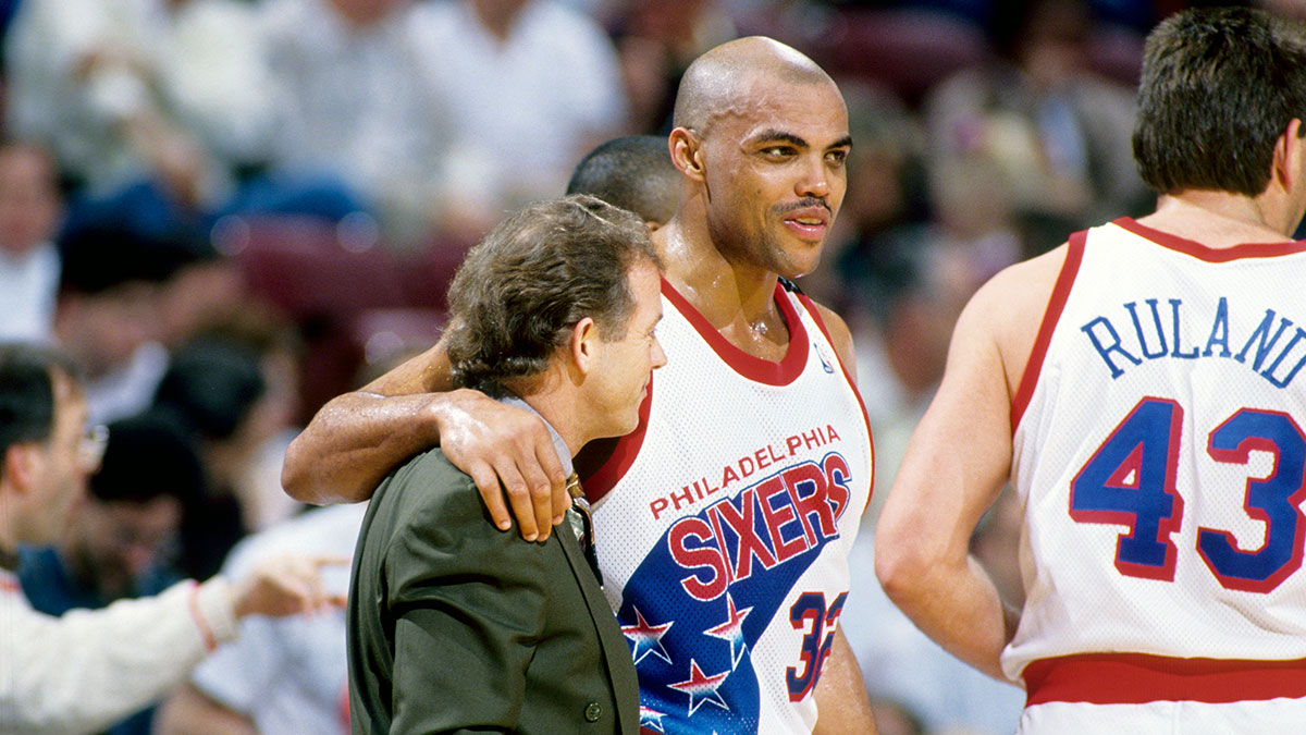Philadelphia 76ers forward Charles Barkley (32) hugs coach Jim Lynam (left) against the Chicago Bulls at the Spectrum.