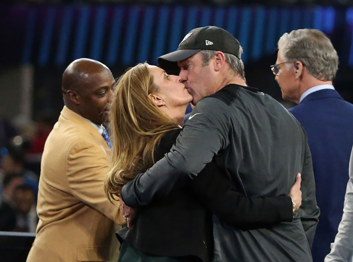 Philadelphia Eagles head coach Doug Pederson kisses his wife Jeannie Pederson after defeating the New England Patriots in Super Bowl LII at U.S. Bank Stadium.