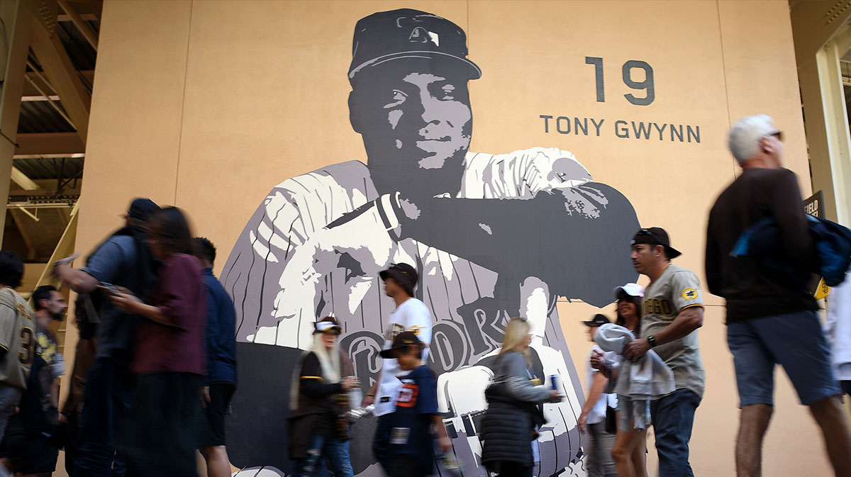 Fans walk the main concourse past a mural of former San Diego Padres player Tony Gwynn before the game between the Padres and the Atlanta Braves at Petco Park.
