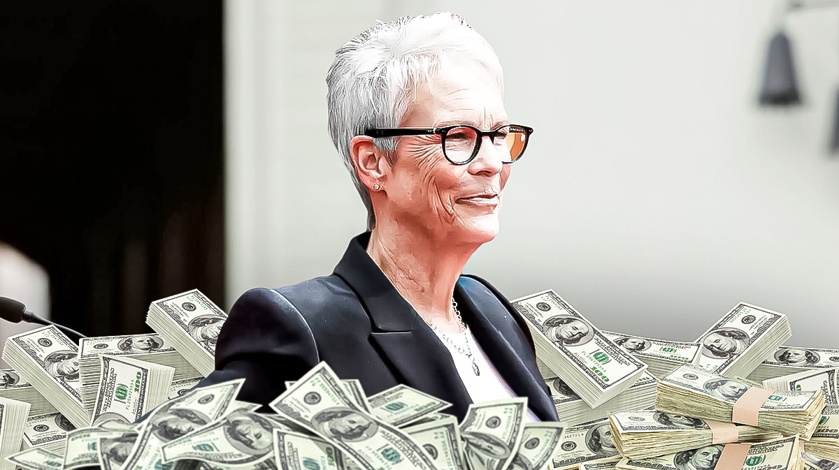 Jamie Lee Curtis surrounded by piles of cash.