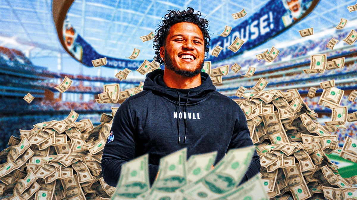 Blake Corum surrounded by piles of cash.