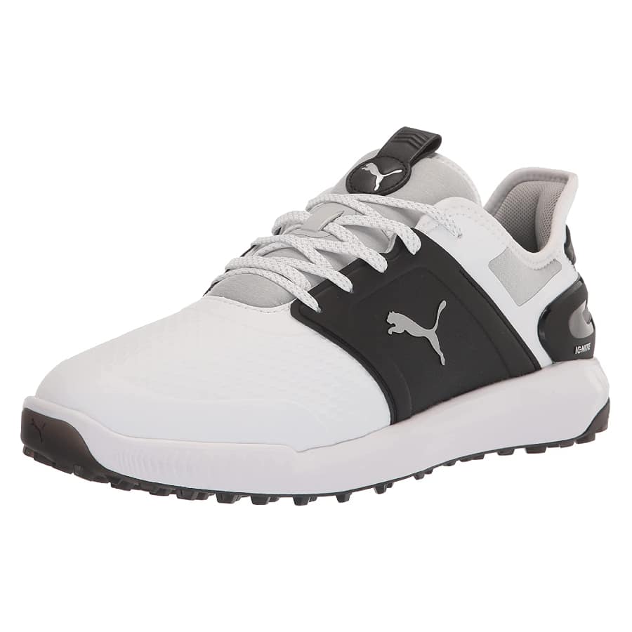 Black and white colored Puma golf shoes on a white background.