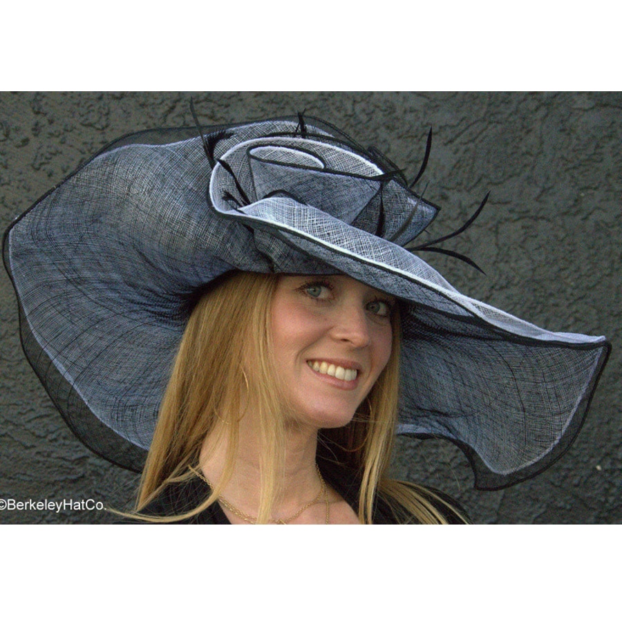 Female model wearing a Berkeley Hat Company Soft Straw Hat for the Kentucky Derby in a grey at with a grey background.