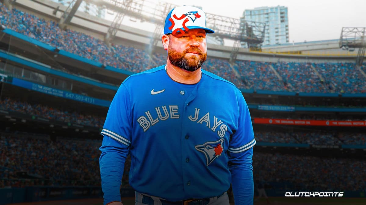 Toronto Blue Jays manager John Schneider, left, plays with his