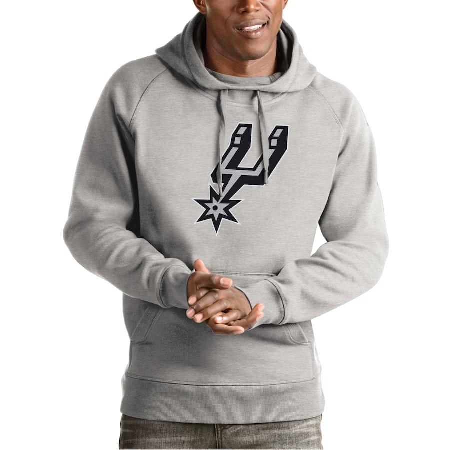 Model wearing a San Antonio Spurs Antigua victory hoodie - Heather gray color on a white background.