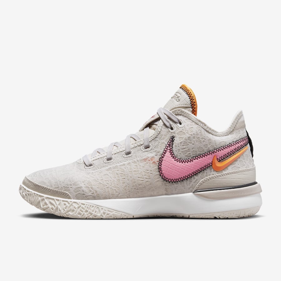 Women's LeBron NXXT Gen - Sail/Coral colorway on a grey background.