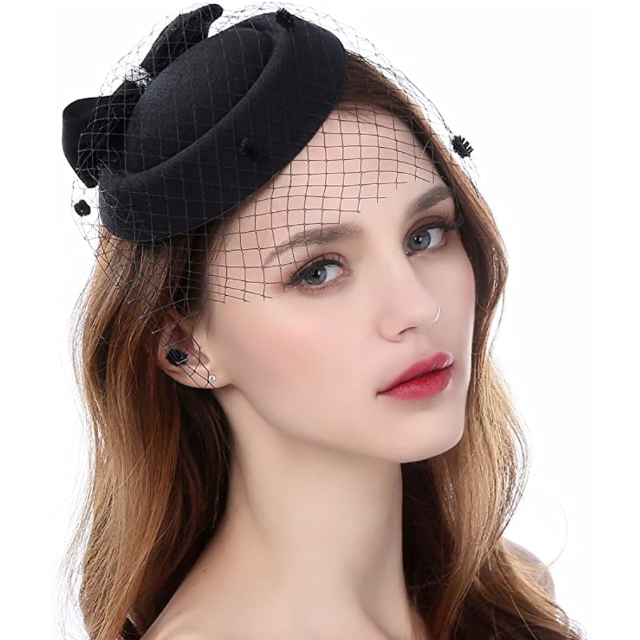 Female model wearing a black Zivyes Fascinator Hats for Women Pillbox Hat with a white background.