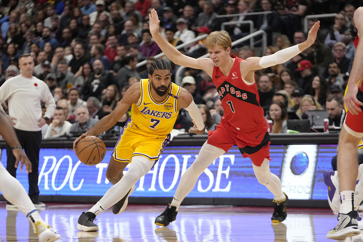 Los Angeles Lakers guard Gabe Vincent (7) drives to the net past Toronto Raptors guard Gradey Dick (1) during the first half at Scotiabank Arena.