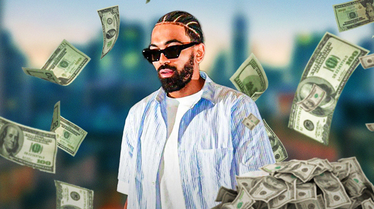 Gabe Vincent surrounded by piles of cash.
