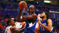 Minnesota Timberwolves Kevin Garnett (center) grabs a rebound alongside center Karl-Anthony Towns (right) against Phoenix Suns guard Eric Bledsoe at Talking Stick Resort Arena. The Suns defeated the Timberwolves 108-101.