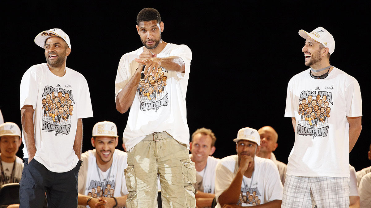 San Antonio Spurs forward Tim Duncan (middle) speaks as teammates Tony Parker (left) and Manu Ginobili (right) listen during NBA championship celebrations at Alamodome.