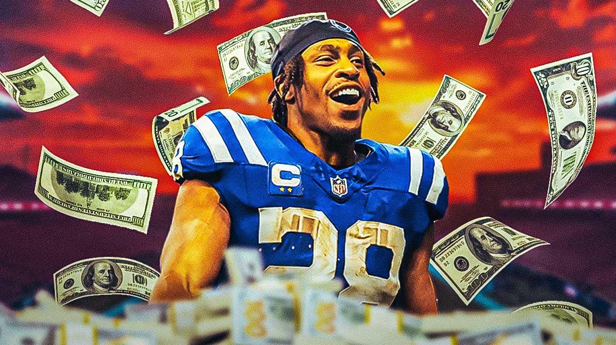Jonathan Taylor surrounded by piles of cash.