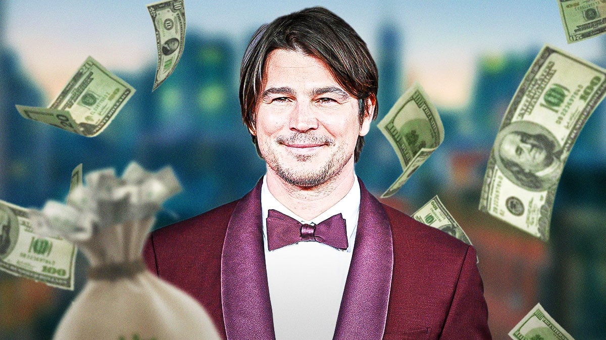 Josh Hartnett surrounded by piles of cash.