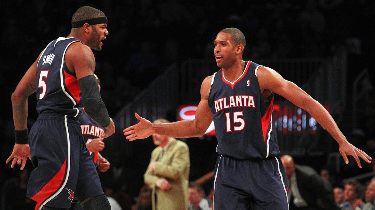 Atlanta Hawks player Josh Smith (5) and Atlanta Hawks Al Horford (15) celebrate during the fourth quarter of an NBA game against the Brooklyn Nets at Barclays Center. The Hawks won 105-93.