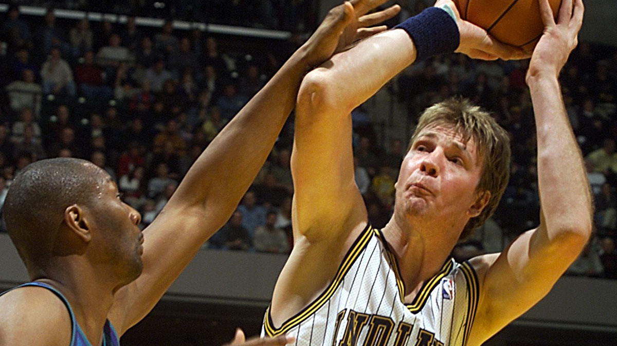 Pacer Rik Smits puts a shot against the defense of Charlotte's Elden Campbell during the first half of their game Thursday night at the Conseco Fieldhouse.