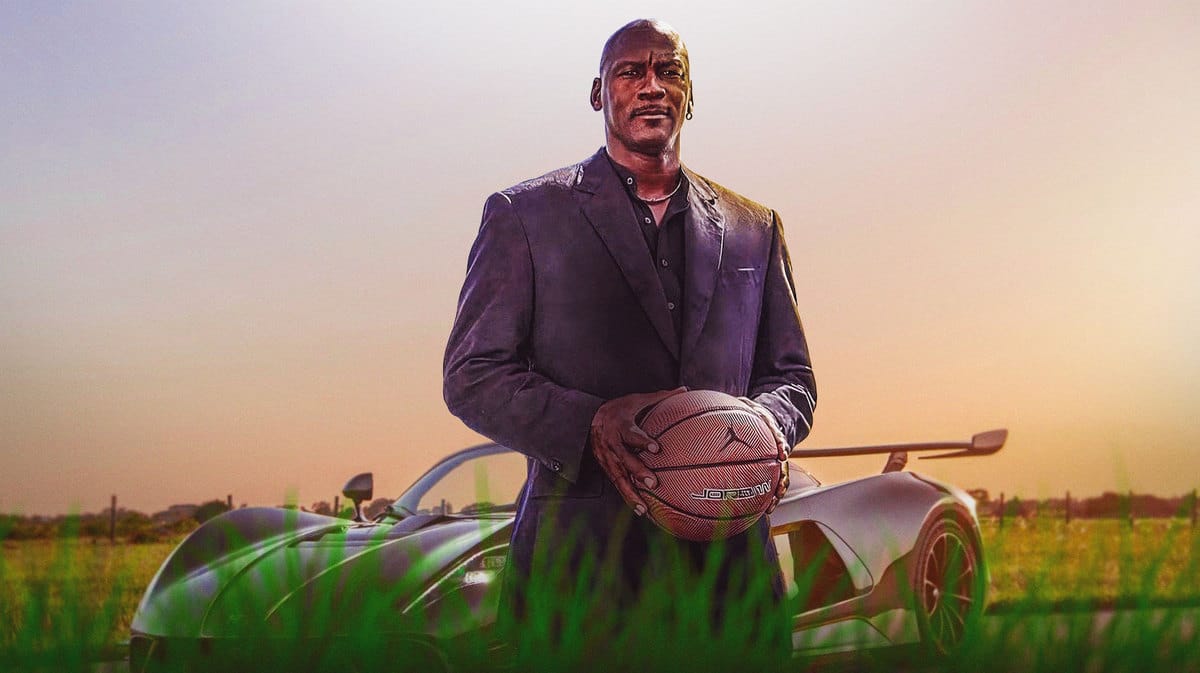 Michael Jordan in front of a sports car from his car collection.