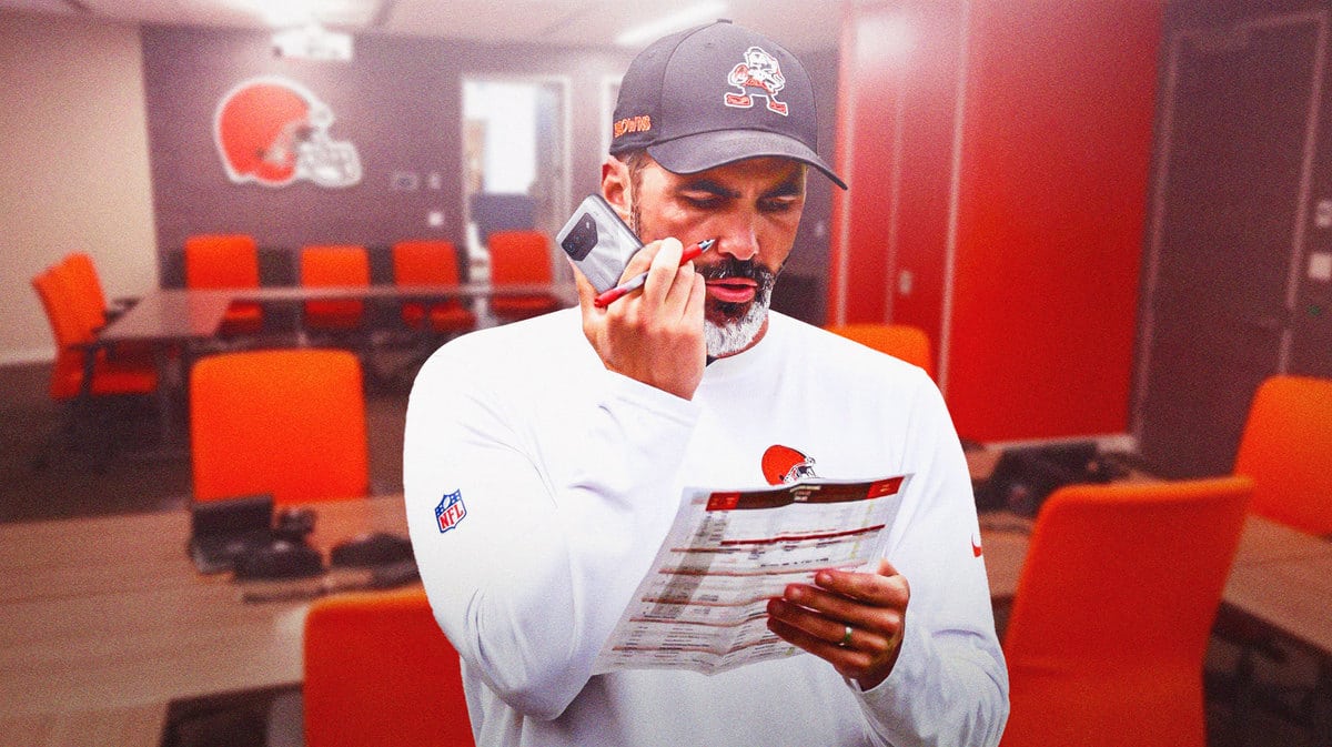 Browns' Kevin Stefanski talking on a phone in an office