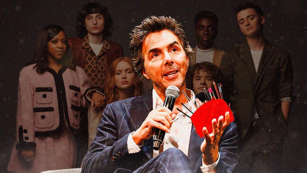 Director Shawn Levy with a makeup bag and the cast of Stranger Things in the background.