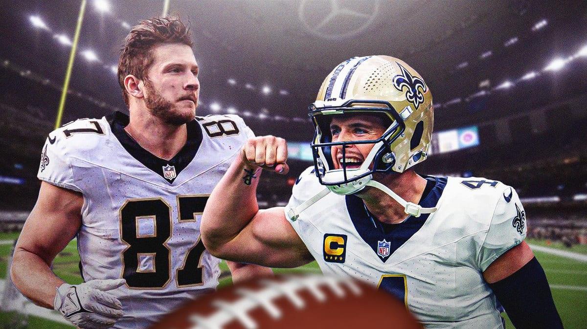 Foster Moreau next to Derek Carr in New Orleans Saints jerseys