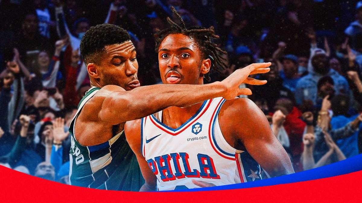 Giannis Antetokounmpo in Bucks jersey fouling Tyrese Maxey in Sixers jersey