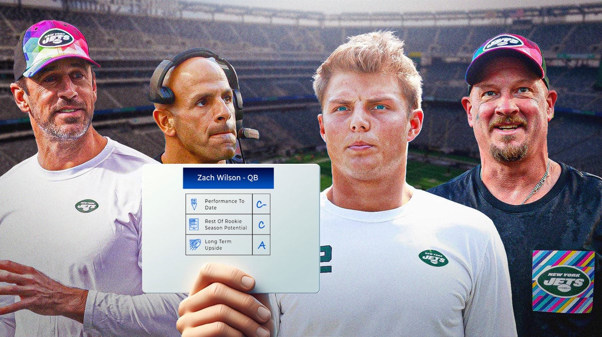 Zach Wilson holding his report card. Looking on are Aaron Rodgers, Robert Saleh and Nathaniel Hackett