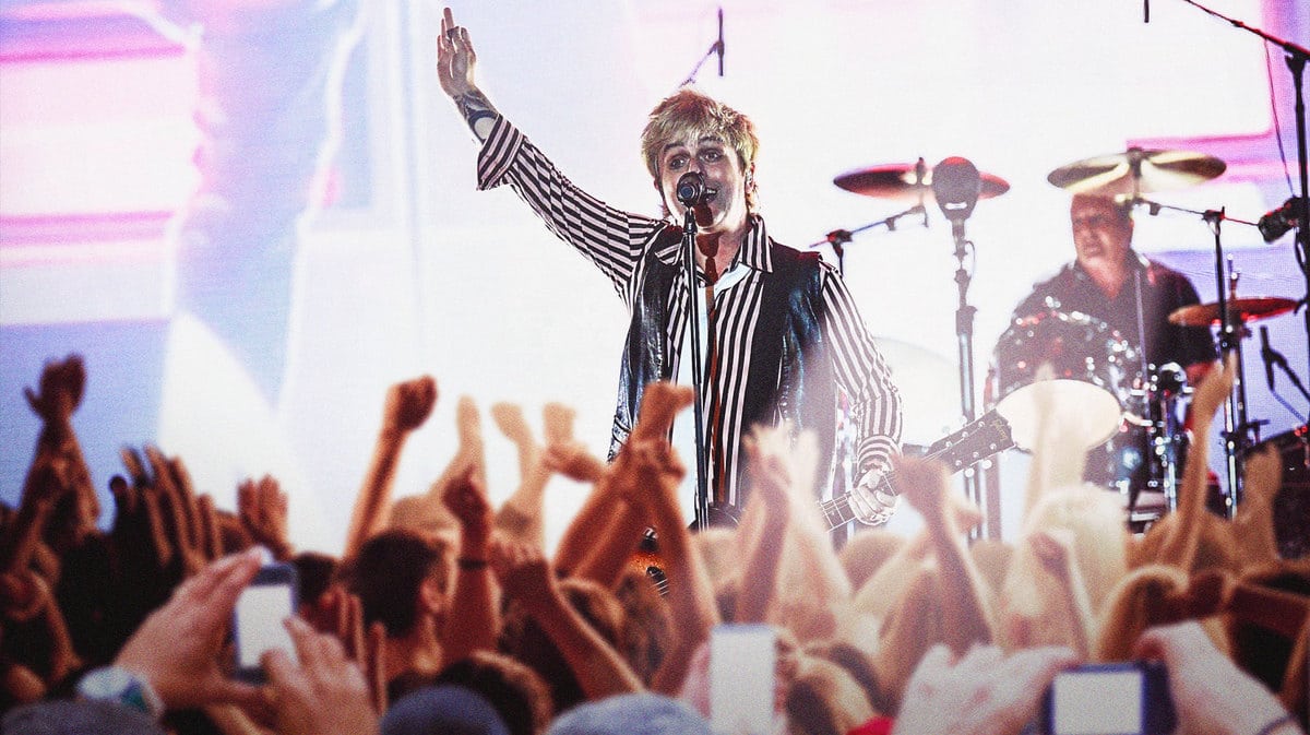 Bille Joe Armstrong and Green Day are playing in front of a big audience.
