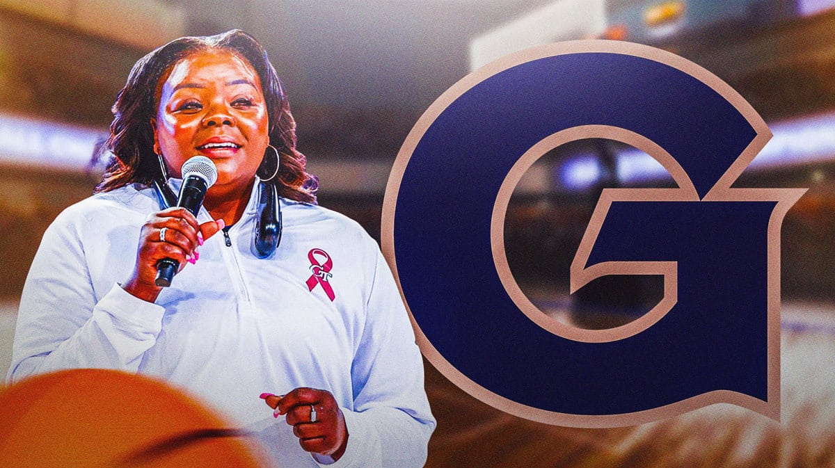 Georgetown head coach Tasha Butts in front of the Georgetown logo and basketball court