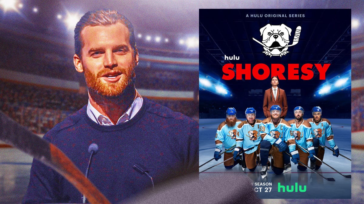 Jared Keeso next to the poster of Hulu show Shoresy with ice rink in background.