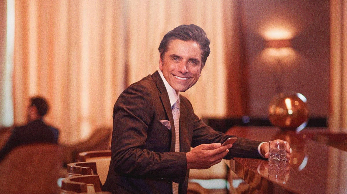 John Stamos surrounded by drinks.