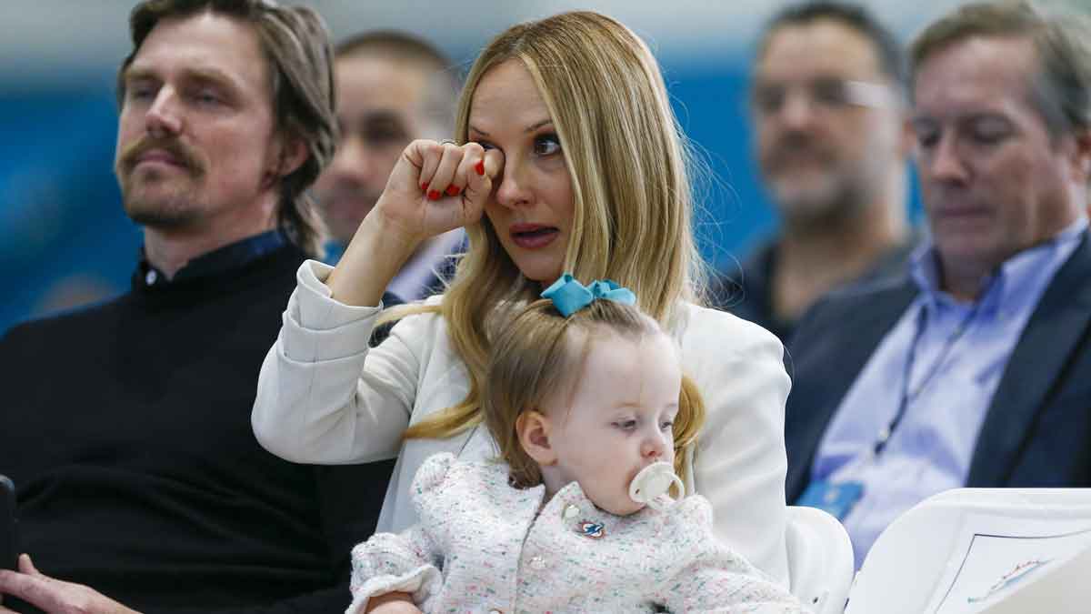 Katie Hemstalk wipes a tear as her husband, Mike McDaniel (not pictured), is introduced as the Miami Dolphins head coach during a press conference at Baptist Health Training Center.