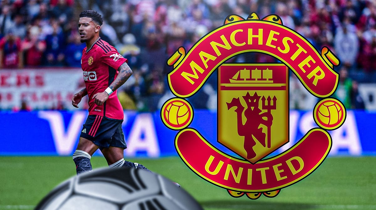 Jadon Sancho walking away from the Manchester United logo