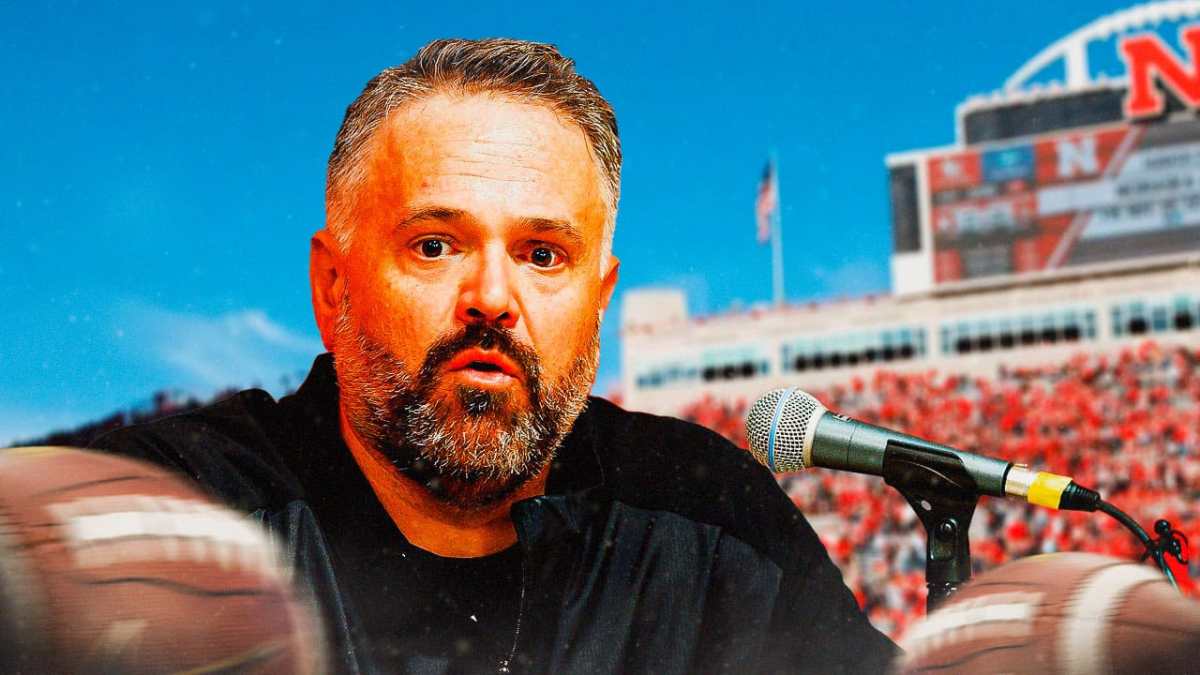 Matt Rhule of Nebraska football holding a mic