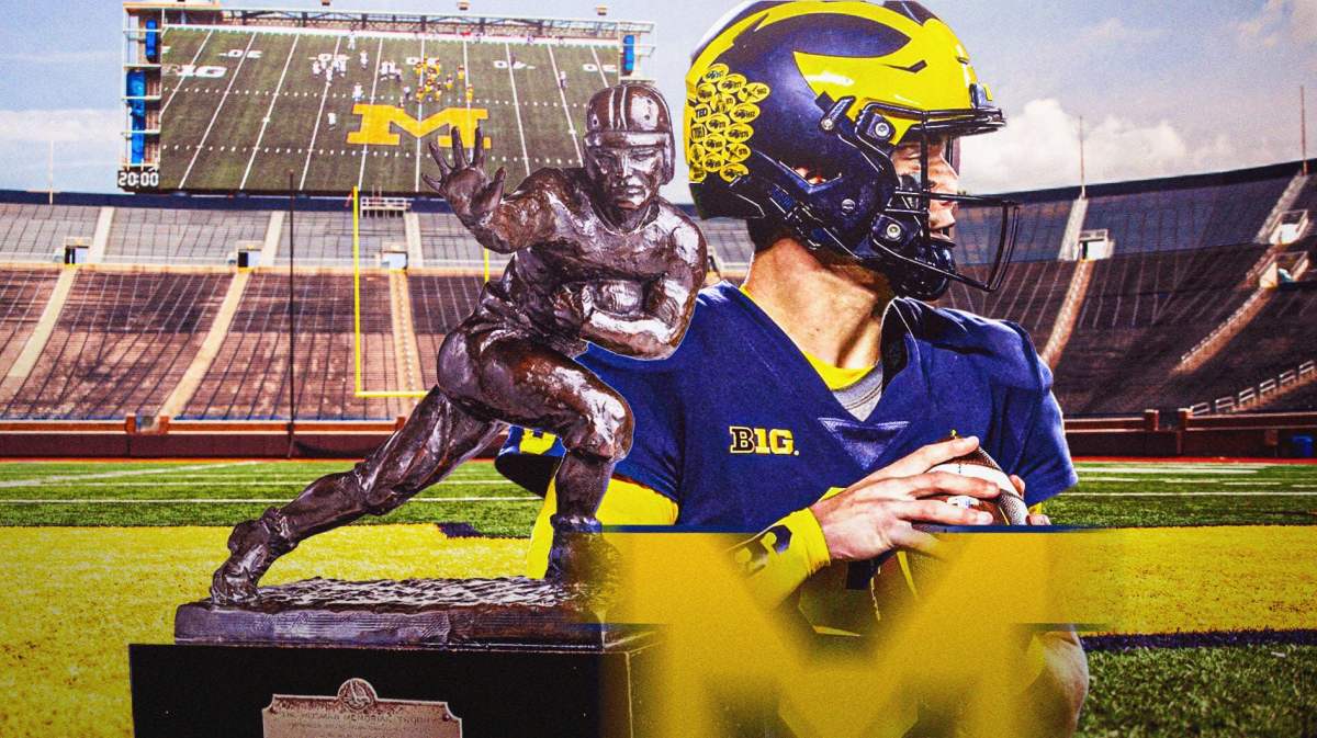 Michigan football, Wolverines, JJ McCarthy, JJ McCarthy Heisman, Heisman, JJ McCarthy and Heisman Trophy with Michigan football stadium in the background