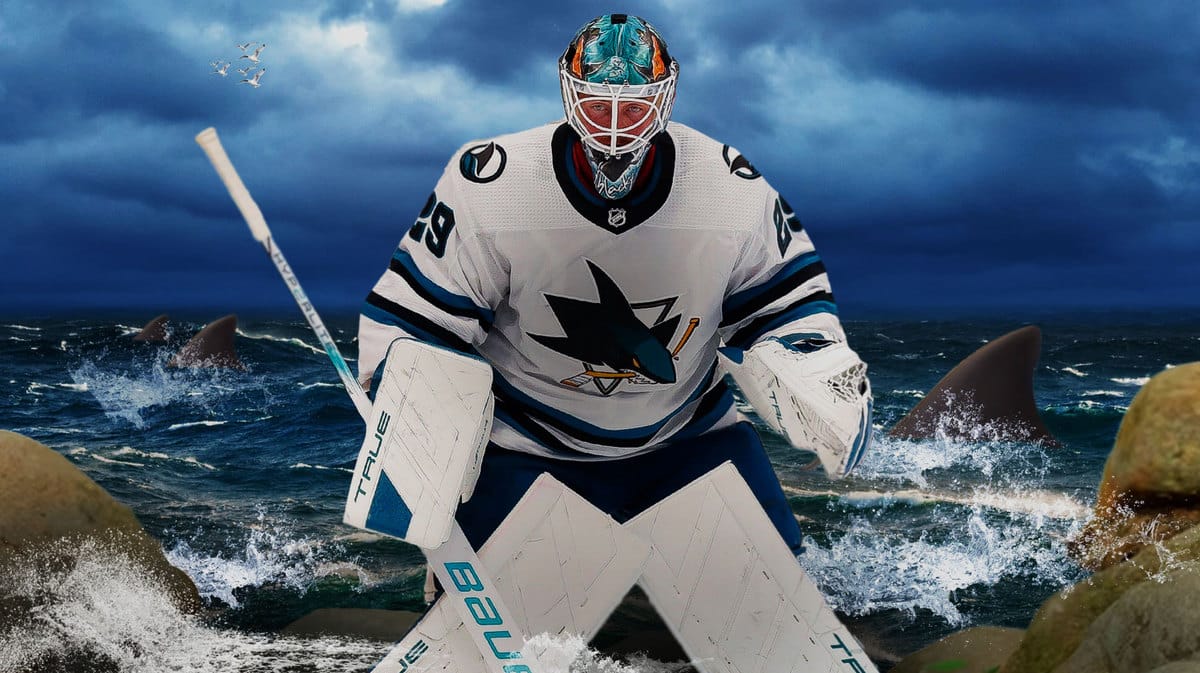 San Jose Sharks goalie Mackenzie Blackwood with an image of sharks swimming in the Pacific Ocean in the background