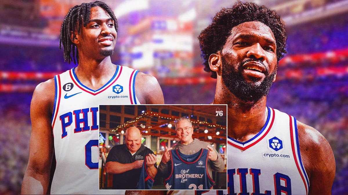 Joel Embiid and Tyrese Maxey in front of a picture of Vincent and James Iovine, owners of a produce store in Philadelphia