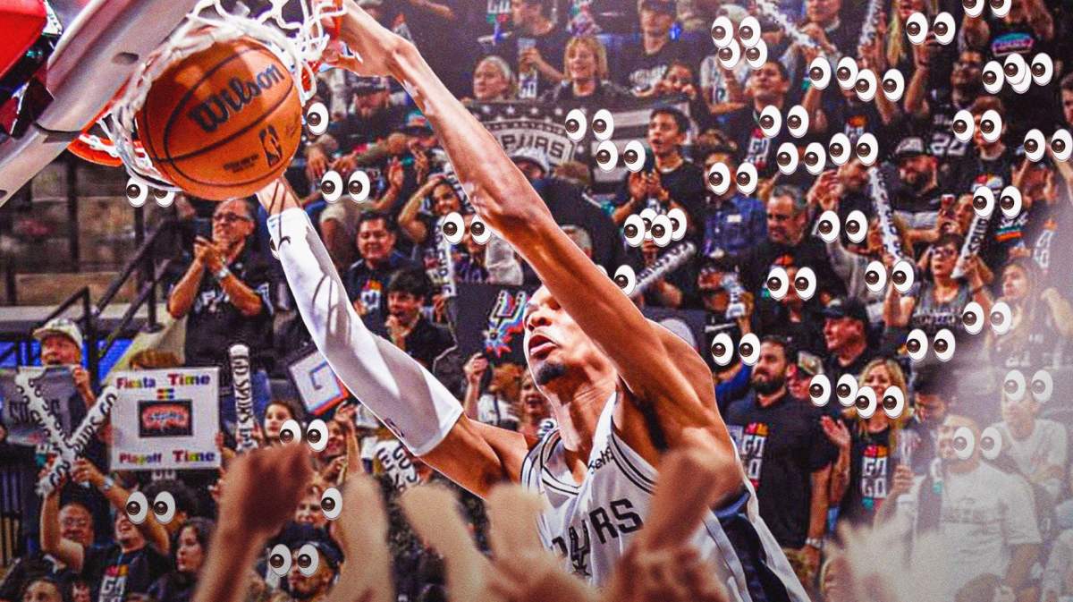 Spurs' Victor Wembanyama dunking a basketball. Spurs fans cheering in background