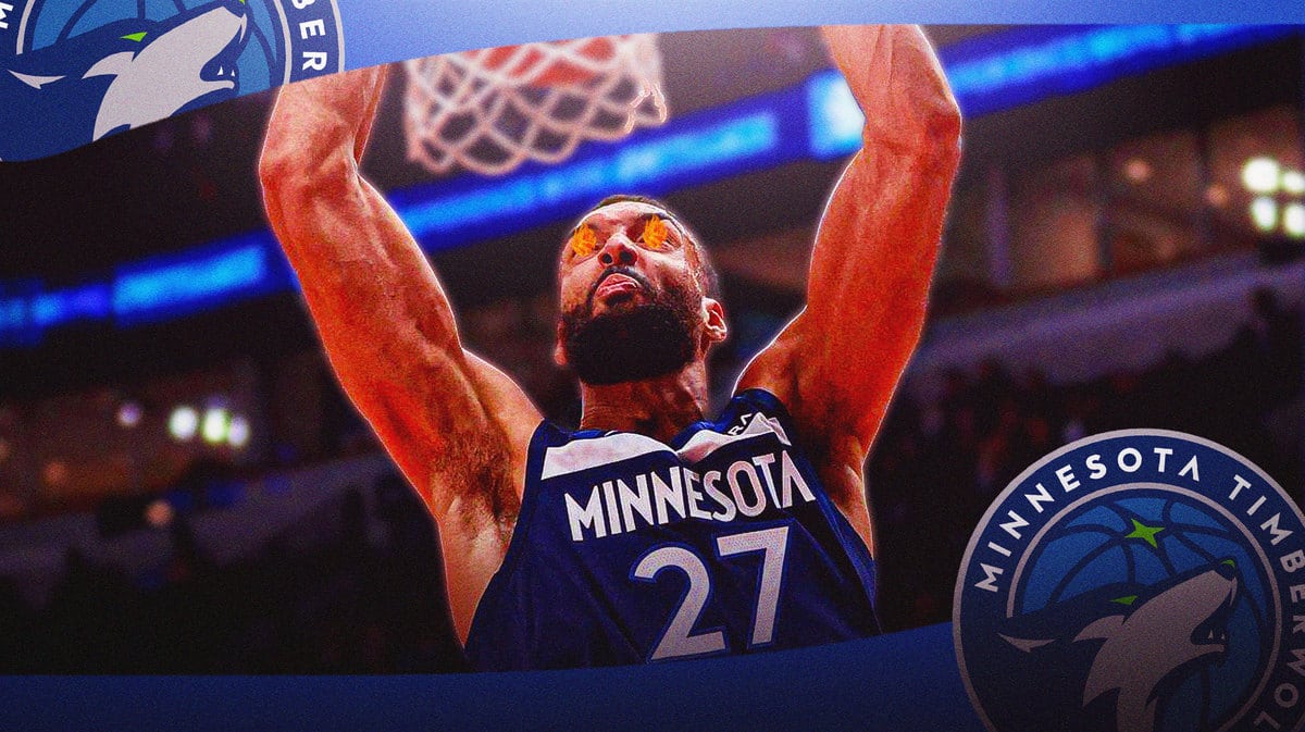 Rudy Gobert dunking a basketball with fire in his eyes