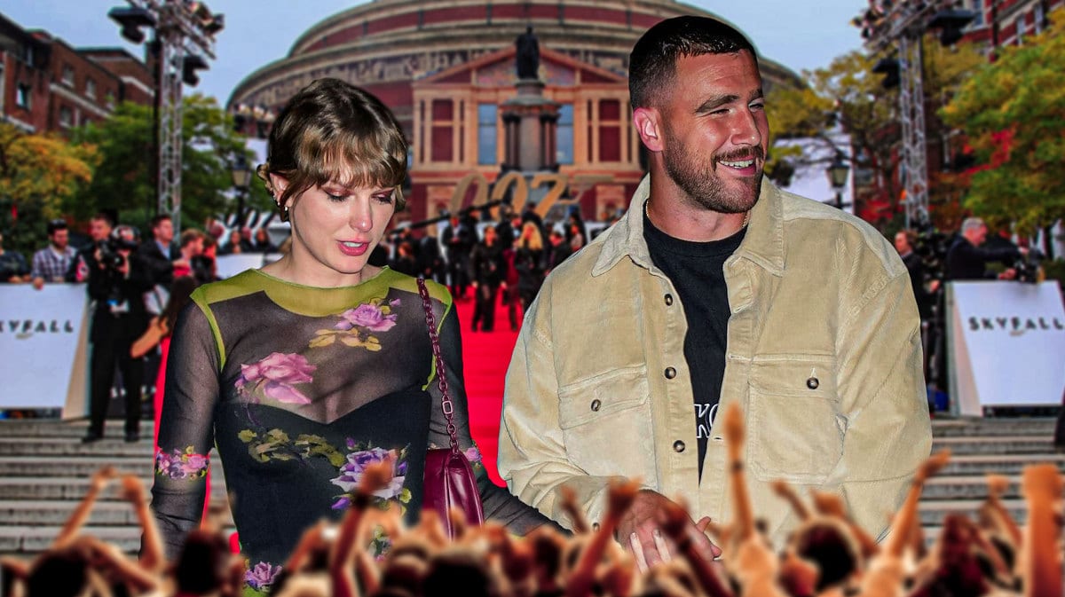 Travis Kelce and Taylor Swift with a happy expression and crowd hands in front.
