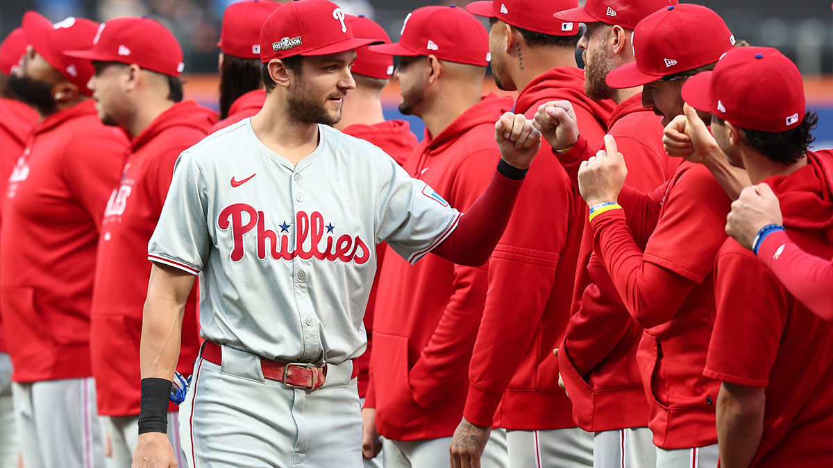 Philadelphia Phillies shortstop Trea Turner (7) fist bumps teammates during introductions before game three of the NLDS for the 2024 MLB Playoffs against the New York Mets at Citi Field.