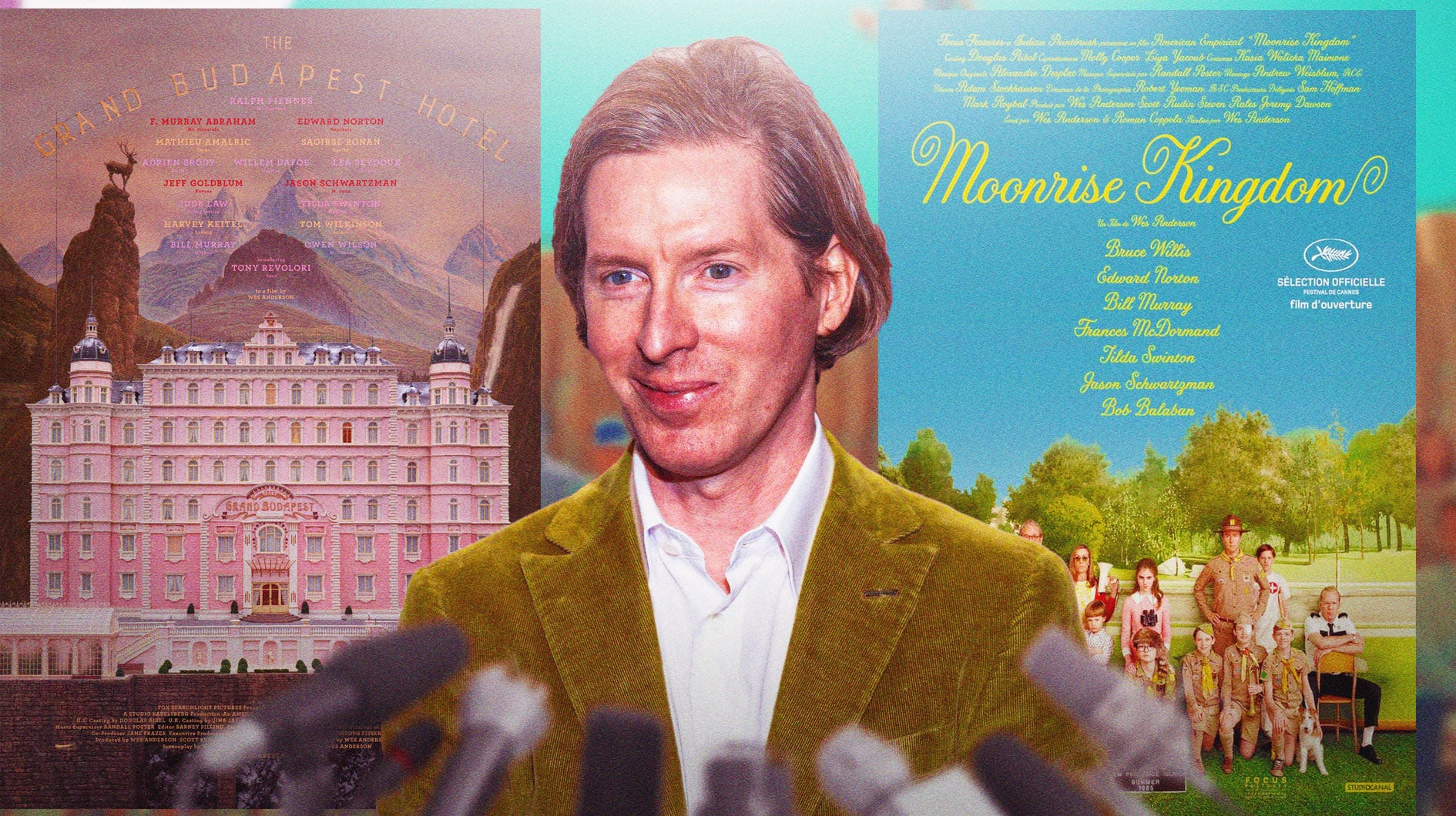 Wes Anderson in front of posters of The Grand Budapest Hotel and Moonrise Kingdom.