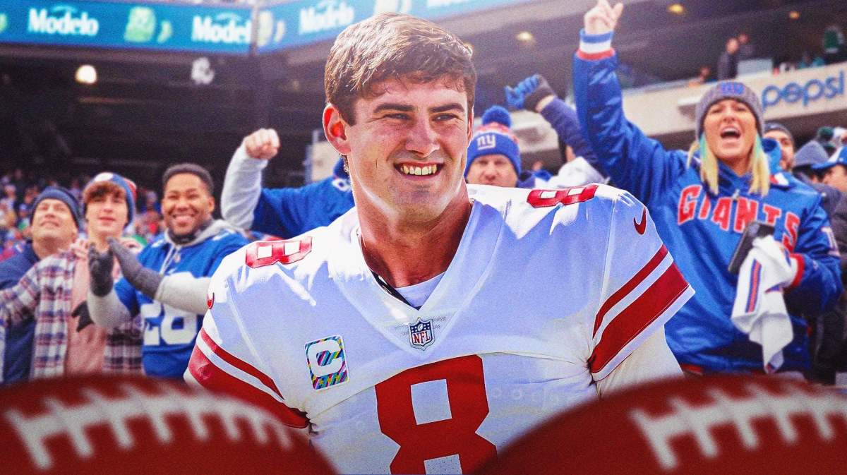 Daniel Jones smiling with New York Giants fans cheering in the background