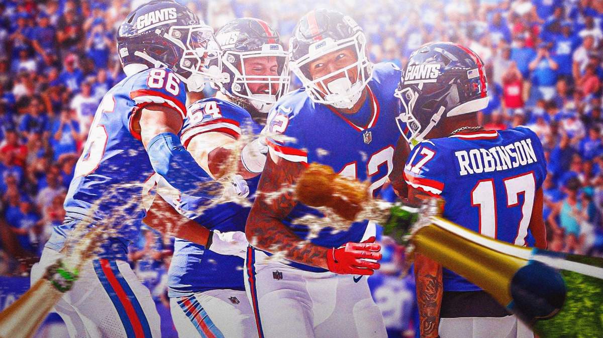 New York Giants players celebrating, with champagne bottles popping in the foreground.