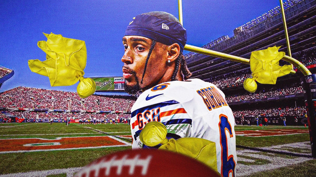 Chicago Bears cornerback Kyler Gordon, without his helmet, with flags flying around him