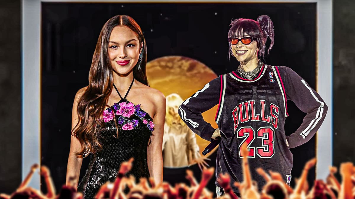 Billie Eilish and Olivia Rodrigo standing in front of the video art from Eilish's Goldwing single.