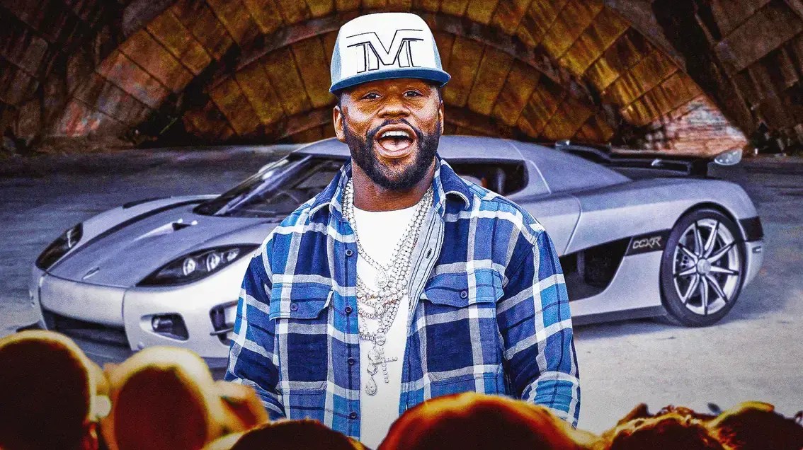 Floyd Mayweather in front of a car from his collection.