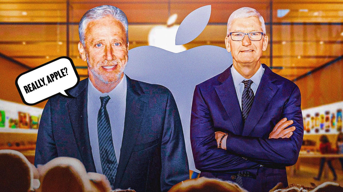 Jon Stewart and Tim Cook stand in front of an Apple store. Stewart has a speech bubble, “Really, Apple?”