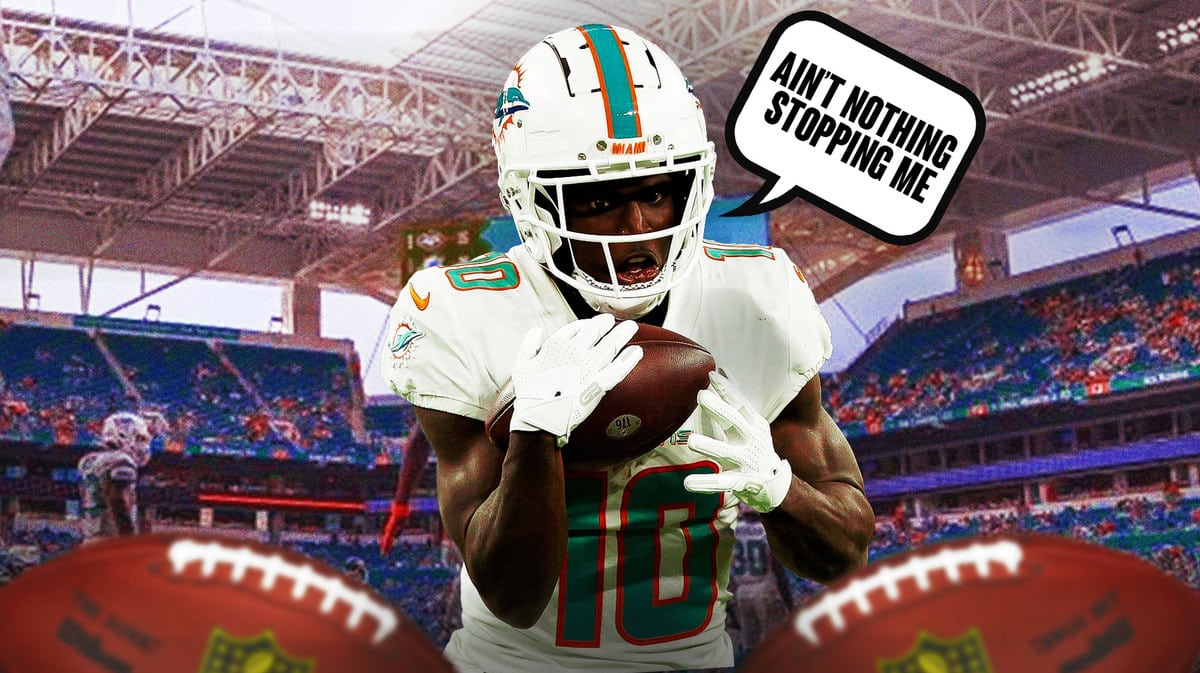 Tyreek Hill in action in Dolphins jersey saying “Ain’t nothing stopping me”