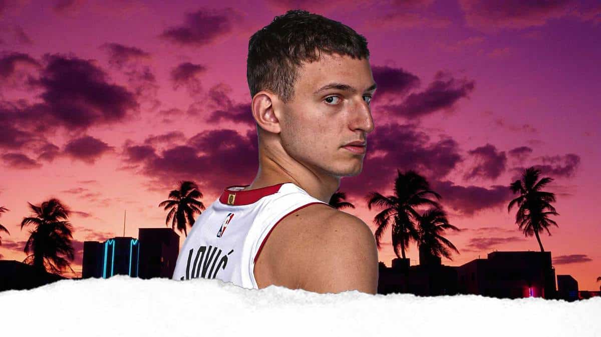 Miami Heat star Nikola Jovic in front of the city's skyline.