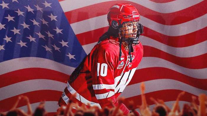 Laila Edwards in her University of Wisconsin hockey uniform in front of an American flag
